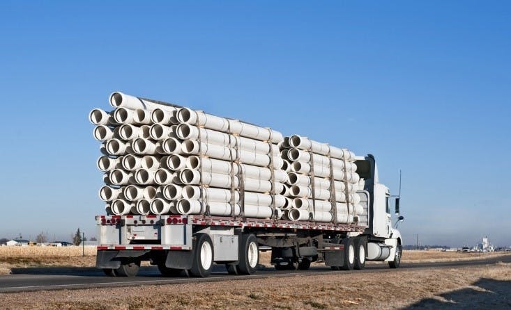 flatbed trailer hauling construction materials