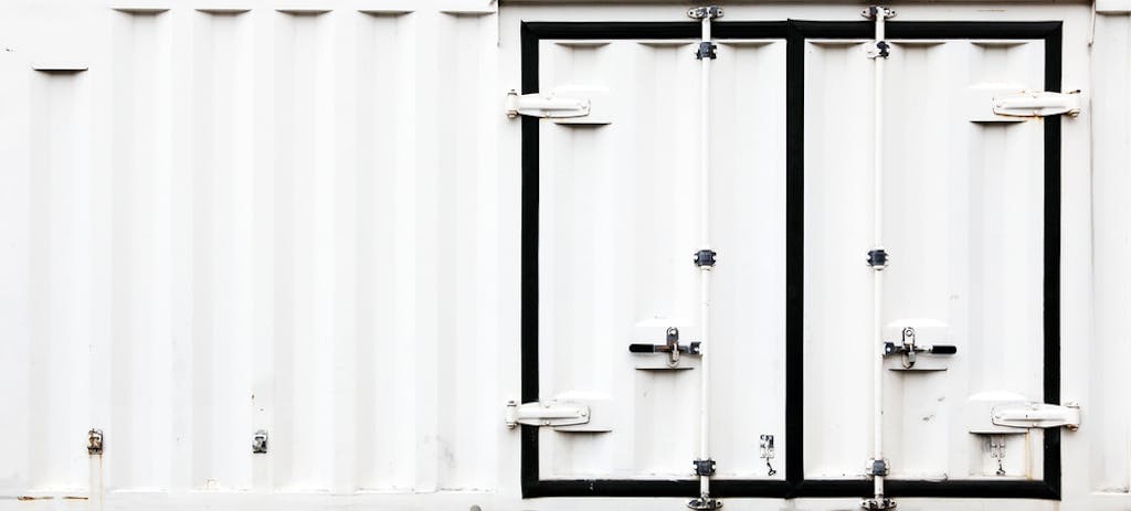 Metal doors with latches on a cargo container being utilized as a vault.