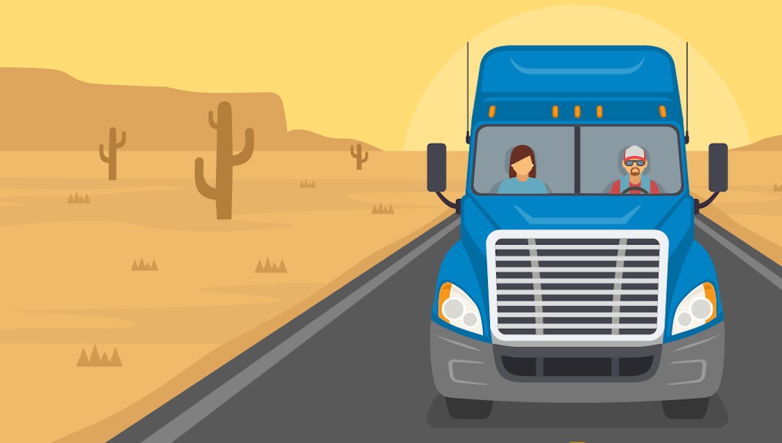 Two truck drivers driving a semi truck down a road in the desert.
