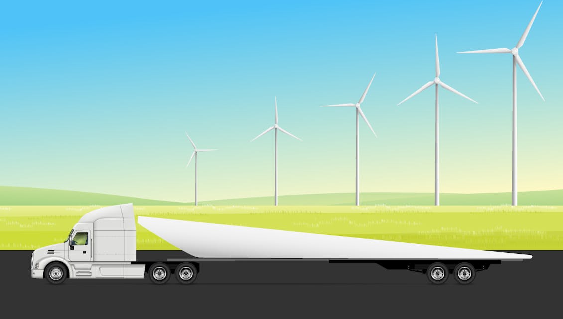 Truck transporting a wind turbine blade driving away from a field of wind turbines.